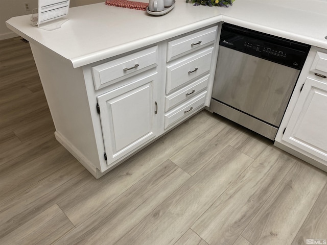 kitchen featuring stainless steel dishwasher and white cabinetry