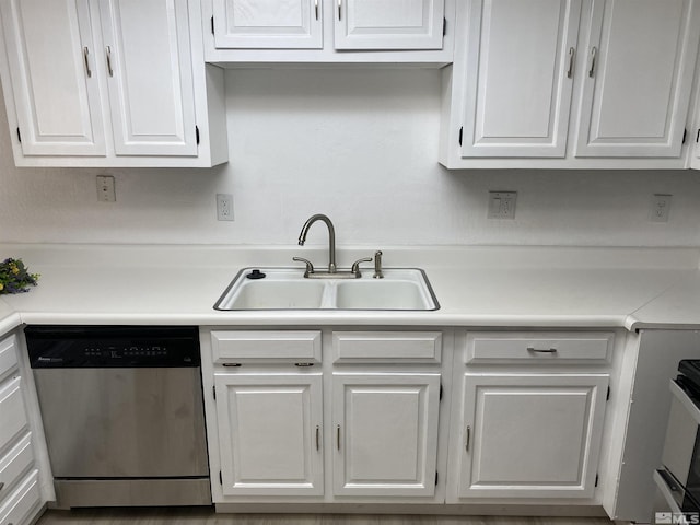 kitchen featuring white cabinets, stainless steel dishwasher, stove, and sink