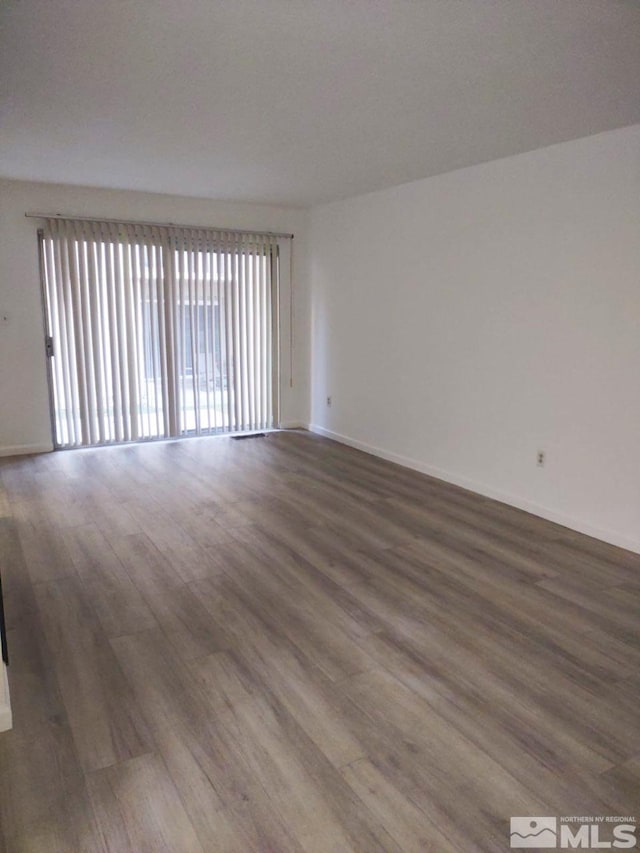 spare room with wood-type flooring