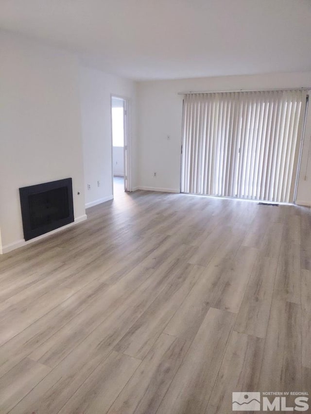 unfurnished living room with light hardwood / wood-style floors