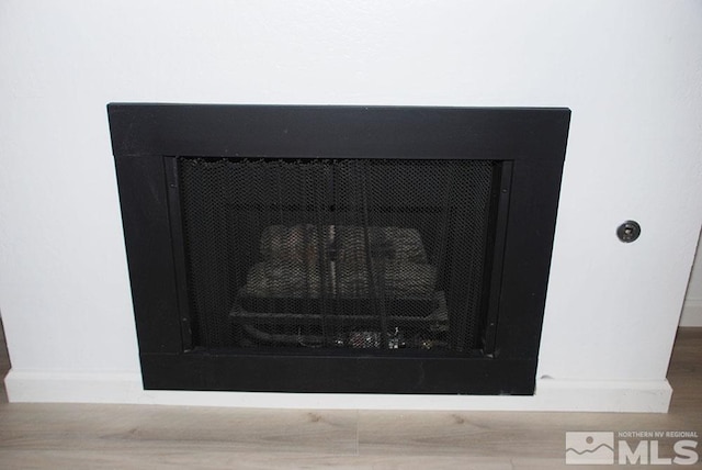 interior details with a fireplace and hardwood / wood-style flooring