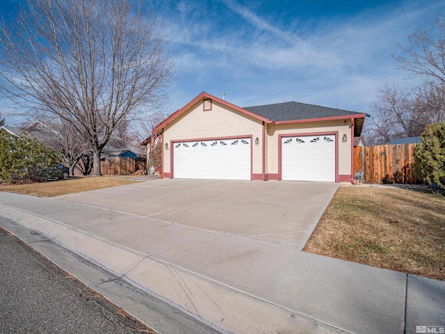 ranch-style home featuring a garage and a front yard