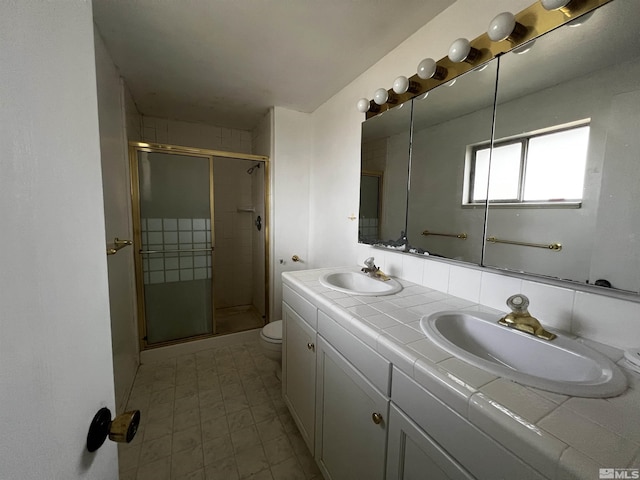 bathroom featuring vanity, toilet, and an enclosed shower