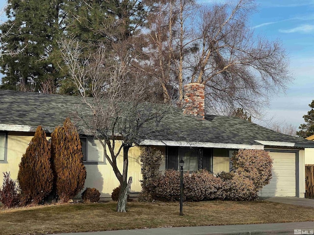 view of property exterior with a lawn and a garage