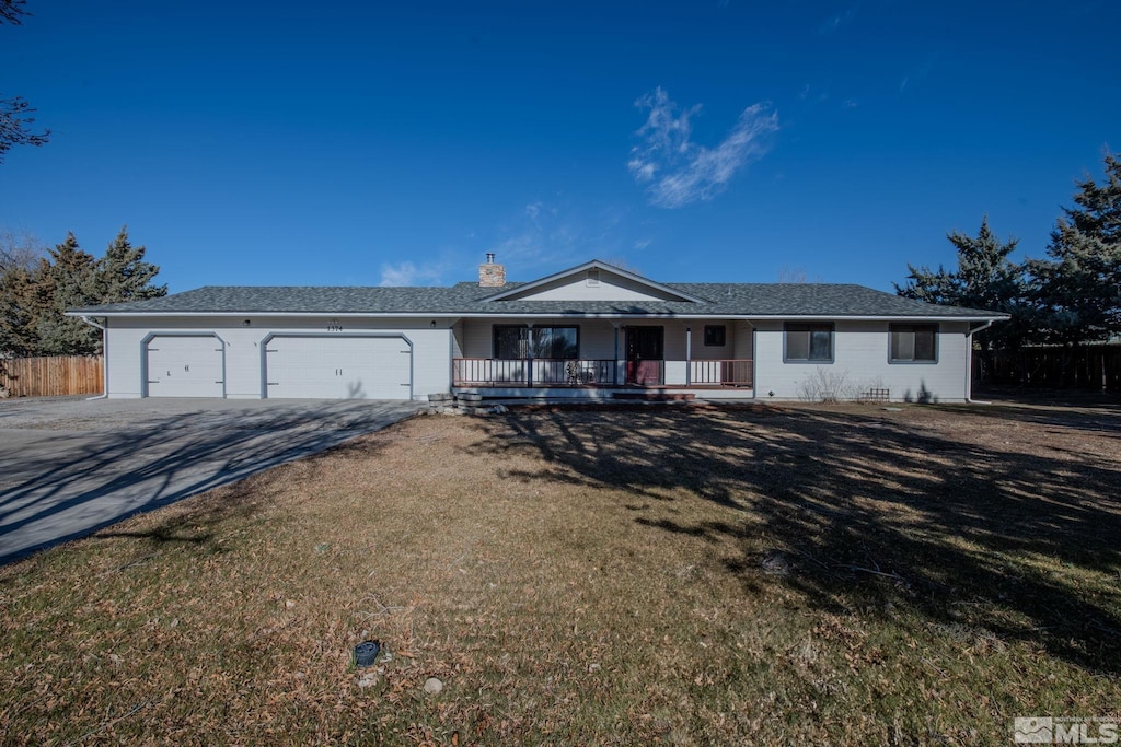 ranch-style home with covered porch, a garage, and a front lawn