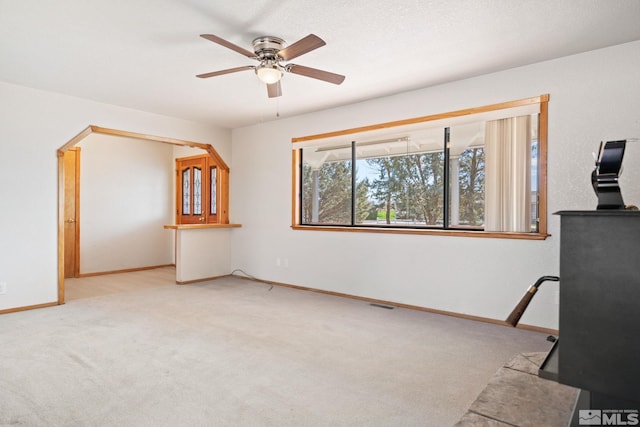 interior space with ceiling fan and light carpet