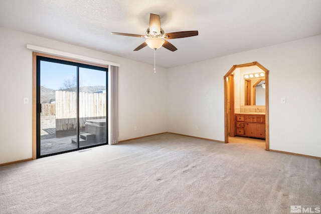 unfurnished room featuring ceiling fan, light colored carpet, a mountain view, and sink