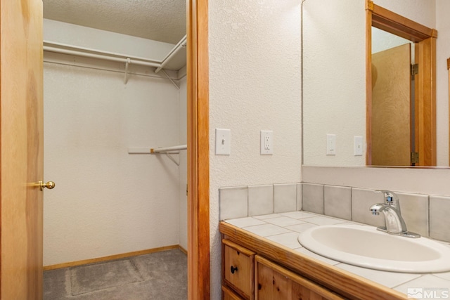 bathroom featuring vanity and a textured ceiling