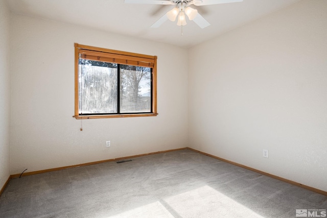 carpeted spare room with ceiling fan