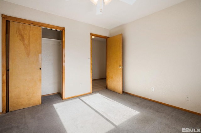 unfurnished bedroom featuring carpet floors, a closet, and ceiling fan