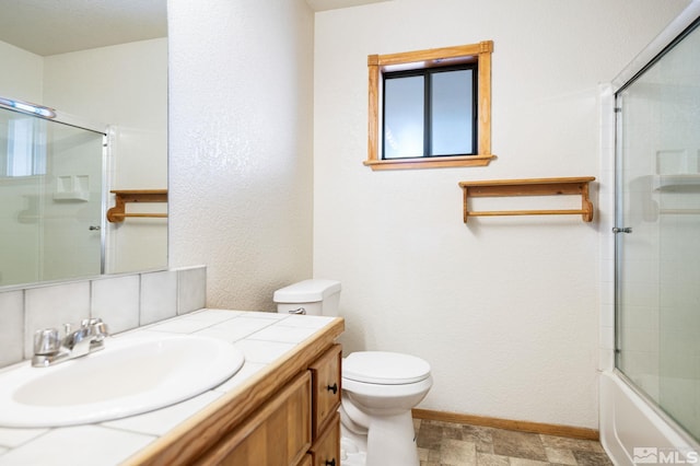 full bathroom featuring vanity, enclosed tub / shower combo, and toilet