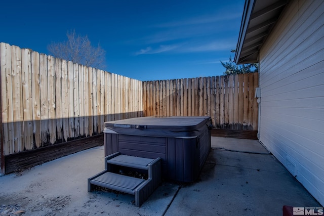 view of patio / terrace with a hot tub