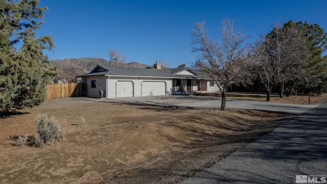 view of front of house with a mountain view and a garage