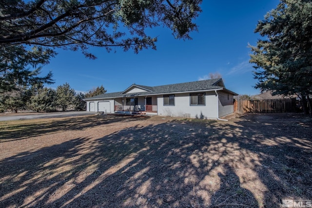 ranch-style home featuring a garage and covered porch