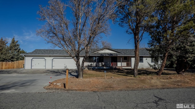 single story home featuring covered porch and a garage