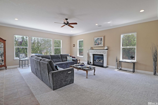 living room featuring a wealth of natural light, crown molding, and ceiling fan