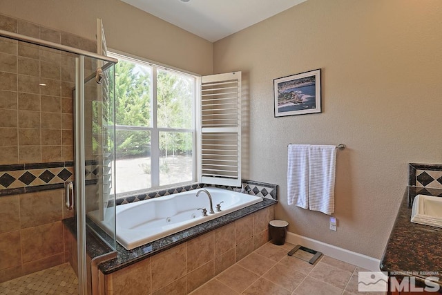 bathroom with tile patterned flooring, vanity, and independent shower and bath