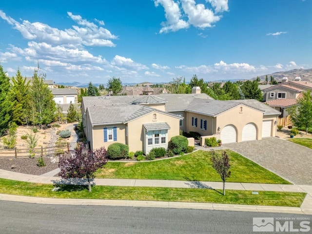 view of front of home featuring a garage and a front lawn