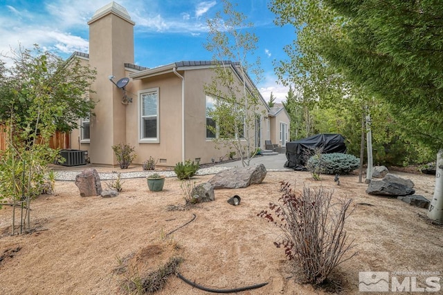 view of side of home featuring a patio and central air condition unit