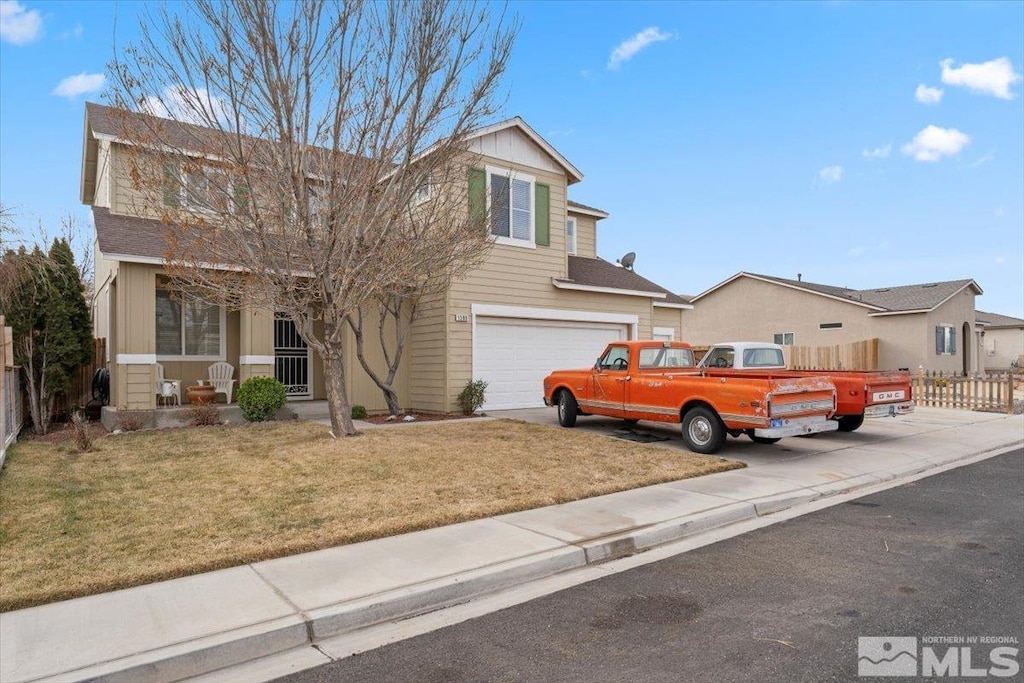 view of front of home with a front yard and a garage