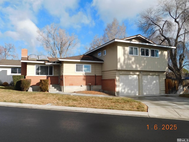 view of front of property with solar panels and a garage