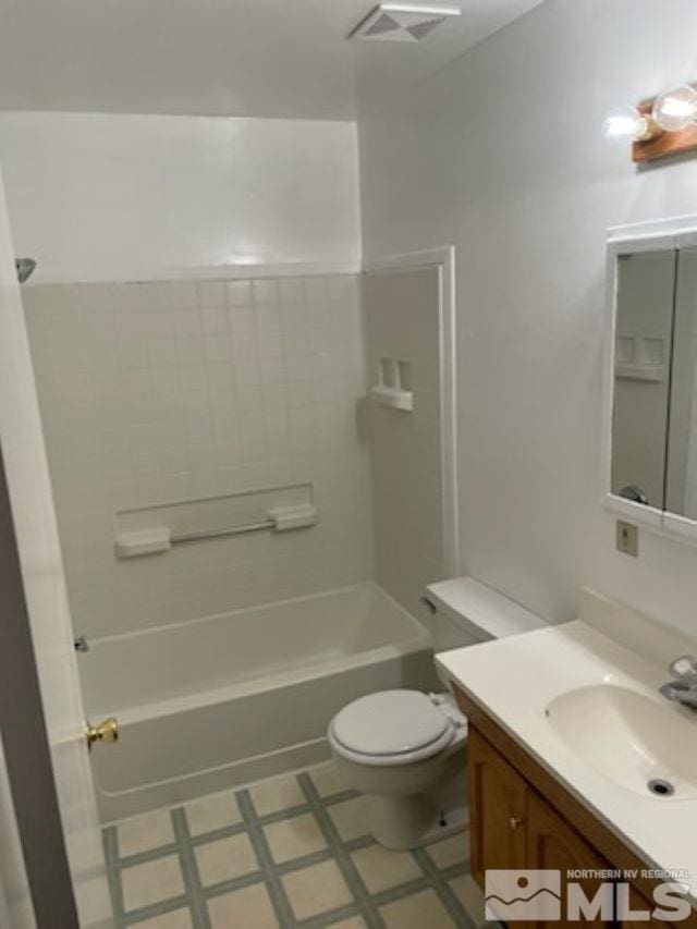 full bathroom featuring toilet, vanity, and washtub / shower combination