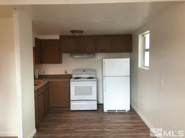 kitchen with dark wood-type flooring, exhaust hood, and white appliances