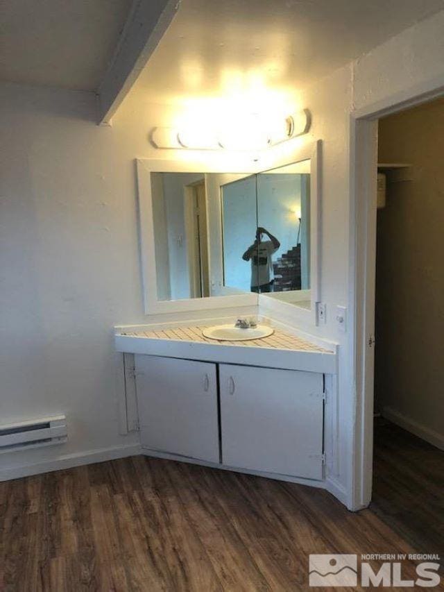 bathroom with vanity, a baseboard radiator, and hardwood / wood-style flooring