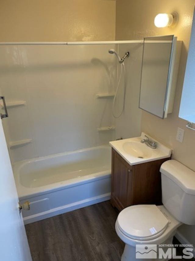 full bathroom with hardwood / wood-style floors, vanity, shower / bath combination, and toilet