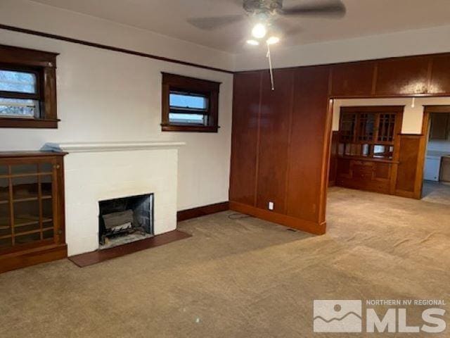 unfurnished living room with ceiling fan and light carpet