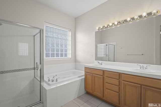 bathroom featuring tile patterned flooring, vanity, and shower with separate bathtub