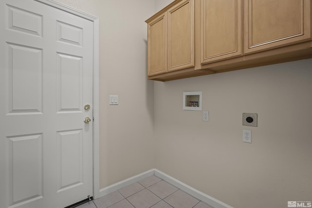 laundry room featuring electric dryer hookup, hookup for a washing machine, light tile patterned floors, and cabinets