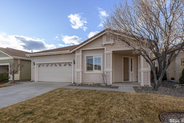 view of front of property with a garage and a front lawn