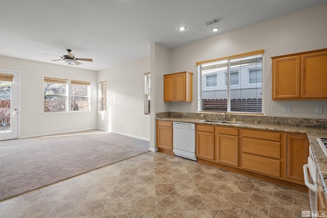 kitchen featuring dishwasher, light colored carpet, ceiling fan, and sink