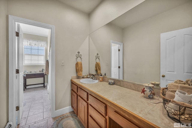 bathroom featuring tile patterned floors, vanity, and a baseboard radiator