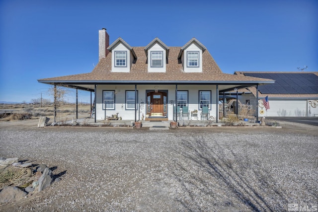 view of front facade featuring covered porch and a garage