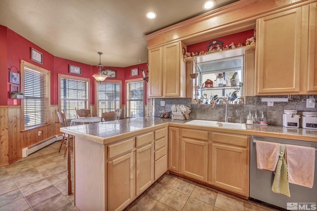 kitchen with kitchen peninsula, sink, a baseboard radiator, dishwasher, and hanging light fixtures