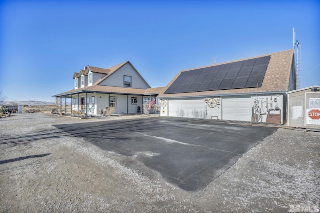 exterior space with solar panels and a garage