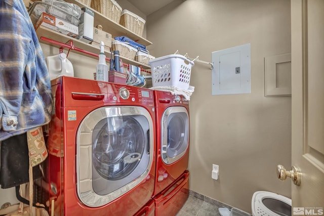 laundry area with tile patterned flooring, washer and dryer, and electric panel