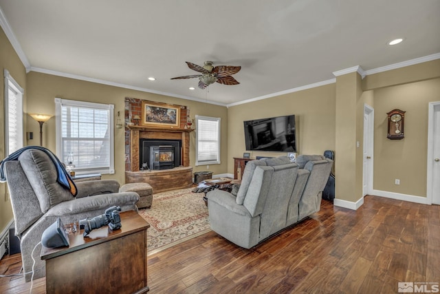 living room with dark hardwood / wood-style flooring, ceiling fan, and ornamental molding