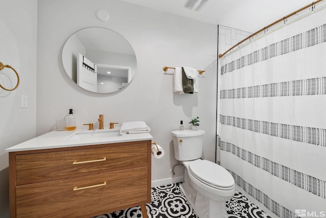 bathroom featuring tile patterned flooring, vanity, toilet, and walk in shower