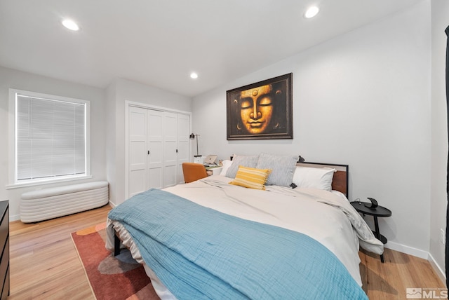 bedroom featuring light hardwood / wood-style flooring and a closet