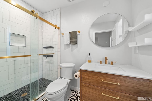 bathroom with vanity, toilet, and a shower with shower door