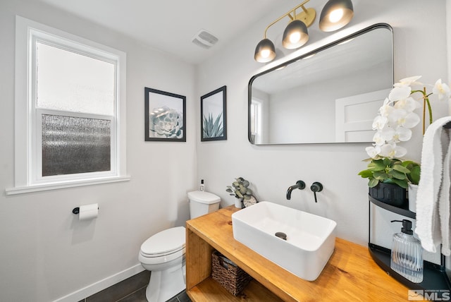 bathroom with tile patterned flooring, vanity, and toilet