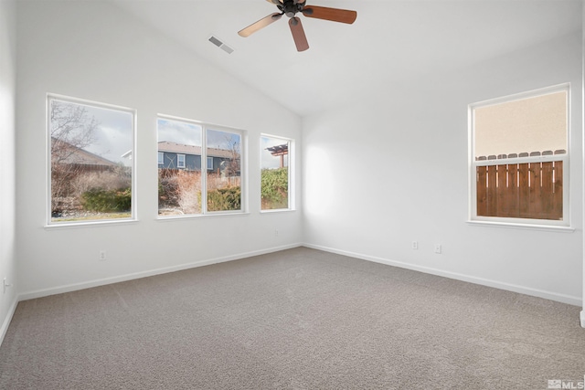 carpeted spare room with ceiling fan and high vaulted ceiling