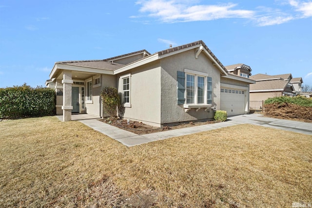 view of front of house with a front yard and a garage