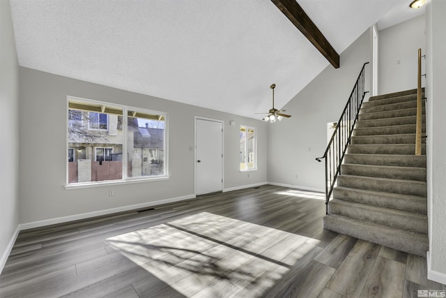 foyer entrance featuring beamed ceiling, dark hardwood / wood-style floors, high vaulted ceiling, and ceiling fan