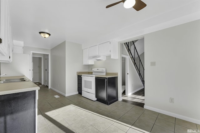 kitchen featuring premium range hood, white cabinetry, sink, and white electric stove