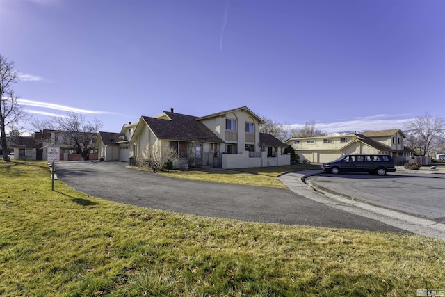 view of front of home with a garage and a front yard