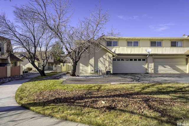 view of front of house with central AC and a garage